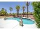 Backyard pool and spa features white coping, desert landscaping, and palm trees at 2209 Purple Majesty Ct, Las Vegas, NV 89117