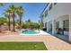 Backyard pool and spa features white coping, desert landscaping, a lawn, and access to the home at 2209 Purple Majesty Ct, Las Vegas, NV 89117