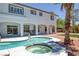 Backyard pool and spa features white coping, a tanning shelf, and access to the home at 2209 Purple Majesty Ct, Las Vegas, NV 89117
