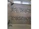 A bathroom shower wall is decorated with gray and neutral toned honeycomb patterned tile at 3275 Arville St # C, Las Vegas, NV 89102