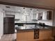 Updated kitchen with stainless steel appliances, a breakfast bar, and modern lighting fixtures at 3275 Arville St # C, Las Vegas, NV 89102