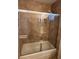 Bathroom featuring a tub and shower with sliding glass doors and neutral tile at 4176 Skywalker Ave, Las Vegas, NV 89120