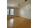 Spacious bedroom with bamboo floors, a ceiling fan, and a large window at 4176 Skywalker Ave, Las Vegas, NV 89120