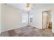 Bedroom with neutral carpet, ceiling fan, and attached bath at 4176 Skywalker Ave, Las Vegas, NV 89120