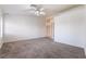 Bright bedroom featuring carpet, a ceiling fan, and a large window at 4176 Skywalker Ave, Las Vegas, NV 89120
