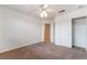 Bedroom featuring neutral carpet, ceiling fan, closet, and an open door to the hall at 4176 Skywalker Ave, Las Vegas, NV 89120