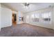 Spacious bedroom with neutral carpet, fireplace, ceiling fan, and natural light at 4176 Skywalker Ave, Las Vegas, NV 89120