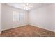 Bedroom with neutral carpet, ceiling fan, and window at 4176 Skywalker Ave, Las Vegas, NV 89120