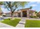 Inviting home with a lush front yard, mature trees, and attractive stone steps leading to the front door at 4176 Skywalker Ave, Las Vegas, NV 89120