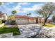 Beautiful home showcasing a manicured front lawn, mature trees, and a spacious three-car garage at 4176 Skywalker Ave, Las Vegas, NV 89120