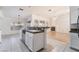 Open kitchen with granite counters that offer views of the living room and fireplace at 4176 Skywalker Ave, Las Vegas, NV 89120