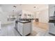 Open kitchen with granite counters that offer views of the living room and fireplace at 4176 Skywalker Ave, Las Vegas, NV 89120