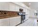 Well-lit kitchen with stainless steel appliances, tile backsplash, and white cabinets at 4176 Skywalker Ave, Las Vegas, NV 89120