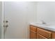 Laundry area featuring a utility sink with wood cabinets and a white door at 4176 Skywalker Ave, Las Vegas, NV 89120