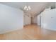 Large open-concept living space featuring light hardwood floors, fresh white paint and modern lighting at 4176 Skywalker Ave, Las Vegas, NV 89120