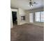 Living room featuring a fireplace, neutral carpet, and a sliding glass door to the backyard at 4176 Skywalker Ave, Las Vegas, NV 89120
