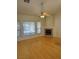 Open living room with bamboo floors, a fireplace, and large windows at 4176 Skywalker Ave, Las Vegas, NV 89120