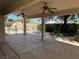 Covered patio area with ceiling fans, view of the rock pool, and landscaped backyard at 4176 Skywalker Ave, Las Vegas, NV 89120