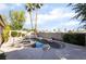 Backyard featuring a uniquely shaped pool, hot tub, and palm trees at 4176 Skywalker Ave, Las Vegas, NV 89120