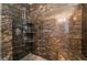 Tiled shower with rock flooring, built-in shelves and dual shower heads at 4176 Skywalker Ave, Las Vegas, NV 89120