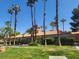 Manicured lawn and mature trees highlighting community building under blue sky at 5220 Mission Carmel Ln # 101, Las Vegas, NV 89107