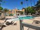 Inviting community pool area with seating and well-maintained grounds; lush trees and buildings in background at 5220 Mission Carmel Ln # 101, Las Vegas, NV 89107