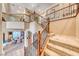 Elegant foyer with hardwood stairs, decorative iron railings, and views of the dining area at 5860 Thai Coast St, Las Vegas, NV 89130