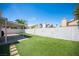 Inviting backyard offers ample space, artificial turf, covered patio, and privacy walls at 7103 Shadow Crest Dr, Las Vegas, NV 89119