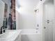 A remodeled bathroom with a luxurious bathtub, marbled walls, and a showerhead at 7103 Shadow Crest Dr, Las Vegas, NV 89119
