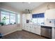 Traditional kitchen features white cabinets, modern appliances, and a window over the sink at 7103 Shadow Crest Dr, Las Vegas, NV 89119