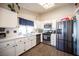 Well-lit kitchen features white cabinets, stainless steel appliances, and a modern aesthetic at 7103 Shadow Crest Dr, Las Vegas, NV 89119
