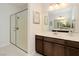 Modern bathroom featuring a glass-enclosed shower, single vanity, and a large mirror creating a bright and open space at 8550 Lost Pony St, Las Vegas, NV 89148