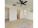Spacious bedroom with neutral carpet, ceiling fan, and attached bathroom at 8550 Lost Pony St, Las Vegas, NV 89148