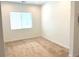 Empty bedroom featuring neutral carpet, window with blinds, baseboards, and freshly painted walls at 8550 Lost Pony St, Las Vegas, NV 89148