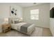 Neutrally decorated bedroom featuring a comfortable bed, soft rug, side tables, and a bright window at 8550 Lost Pony St, Las Vegas, NV 89148