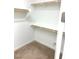 Walk-in closet with carpet and built in wooden shelving and bars for hanging at 8550 Lost Pony St, Las Vegas, NV 89148
