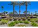 Community entrance with palm trees and lush landscaping at 8550 Lost Pony St, Las Vegas, NV 89148