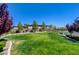 Manicured community lawn surrounded by trees, shrubs, and well-maintained landscaping. Ideal for recreation and relaxation at 8550 Lost Pony St, Las Vegas, NV 89148