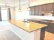 Open kitchen features a large island with pendant lighting and stainless steel appliances at 8550 Lost Pony St, Las Vegas, NV 89148