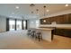 Open-concept kitchen boasts an island with seating and seamlessly connects to the living area with large windows at 8550 Lost Pony St, Las Vegas, NV 89148