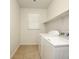 Well-lit laundry room with modern appliances and convenient shelving at 8550 Lost Pony St, Las Vegas, NV 89148