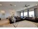 Cozy living room features a plush leather sofa, patterned rug, and large windows, creating a comfortable atmosphere at 8550 Lost Pony St, Las Vegas, NV 89148