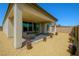 Covered patio with comfortable seating and landscaped backyard at 8550 Lost Pony St, Las Vegas, NV 89148