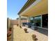 Covered patio with a cozy seating area and manicured landscaping at 8550 Lost Pony St, Las Vegas, NV 89148