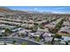 A wide aerial view of a housing development with numerous homes, streets, and mountain ranges in the background at 10018 Regency Square Ave, Las Vegas, NV 89148