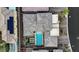 Stunning aerial view of a home with a sparkling pool, lush landscaping, and rooftop solar panels at 10018 Regency Square Ave, Las Vegas, NV 89148