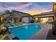 The backyard with pool, desert theme, patio, and desert sunset is ready for fun and entertaining at 10018 Regency Square Ave, Las Vegas, NV 89148