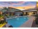 The backyard with pool, desert theme, patio, and desert sunset is ready for fun and entertaining at 10018 Regency Square Ave, Las Vegas, NV 89148