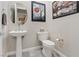 Cozy half-bathroom features sleek fixtures and grey tiling at 10018 Regency Square Ave, Las Vegas, NV 89148