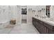 Luxury bathroom featuring a marble shower, dual vanities, and a walk-in closet at 10018 Regency Square Ave, Las Vegas, NV 89148